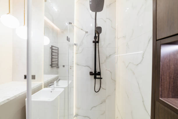 istock new clean empty bathroom with glass shower and white tiles 1393783938