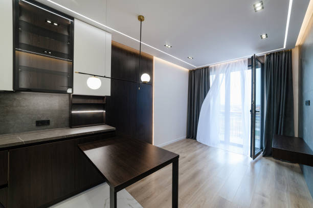 istock Modern Studio Kitchen Interior With Dark Furniture Large Window Lighting 1393784129