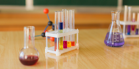 Color reagents in test tubes and flasks are on the table. Study chemistry. Natural Sciences. Desk. Classroom. Laboratory at the university. Biolaboratory. Science.