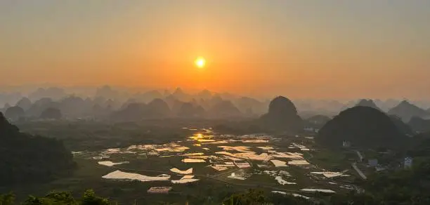 Karst area of the sunset.
China,Guilin,Yangshuo county,"Putao"township,rural areas.
This is one of the famous scenic spots in Guilin lijiang river scenery.
It belongs to the world Natural heritage - part of Guilin karst landform.
On sunny days, the sunset here is spectacular!
This photo was taken on a cell iphone13 mini.