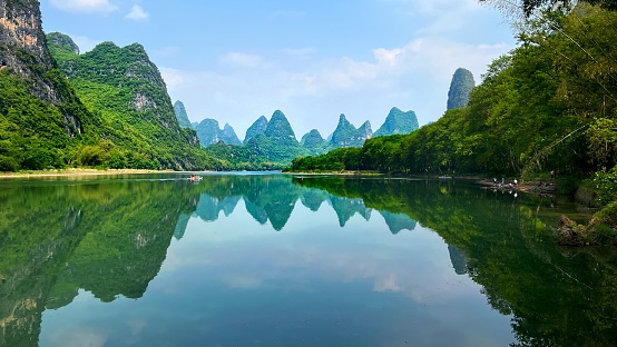 China,Guilin,Yangshuo county.\nBeautiful Lijiang River,is the world's largest and most beautiful karst landscape scenic resort.\nLijiang River along the karst peak forest landform,continuous,\ndifferent forms,very spectacular.\nThis photo was taken on a cell iphone13 mini.