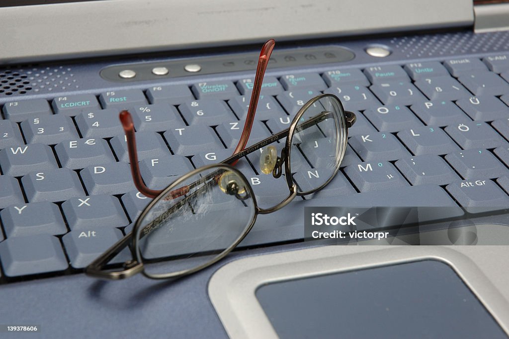 Glasses and laptop glasses lying on laptops keyboard  Alphabet Stock Photo