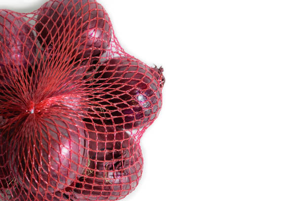 istock Red onion in a shopping plastic mesh. Close-up, copy space 1393788488