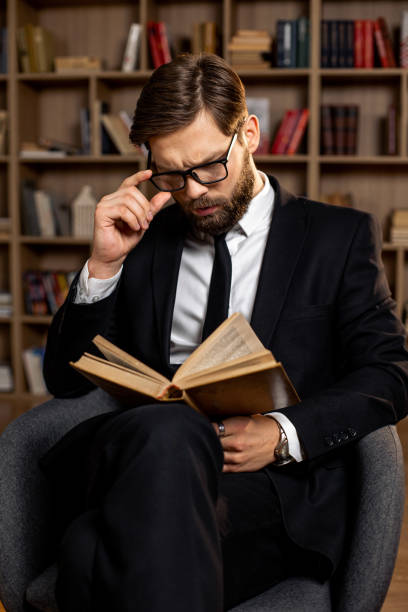 istock A young businessman reading a book 1393790020