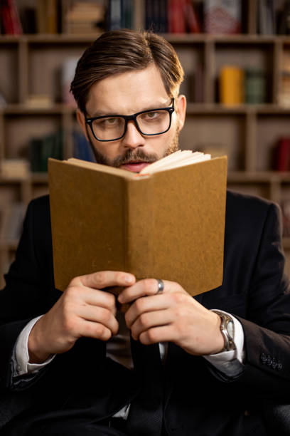 istock A young businessman reading a book 1393790034