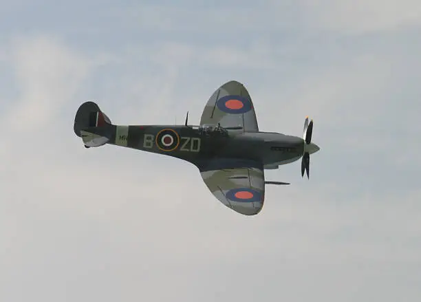 Spitfire banking during a commemorative airshow.