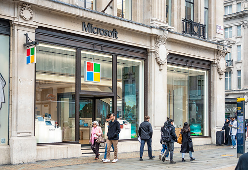 London, UK - Pedestrians on Regent Street in London's West End, passing a Microsoft Store.
