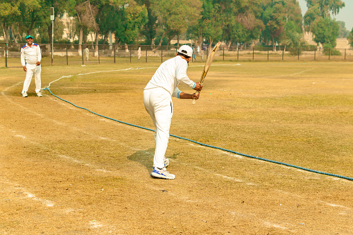 cricket players practicing in match ground