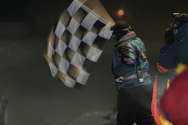 Flagger at NASCAR waving the checkered flag