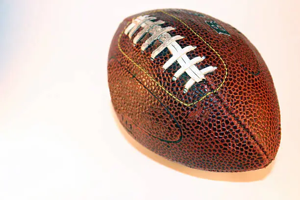 A football isolated on white, focus on the right.