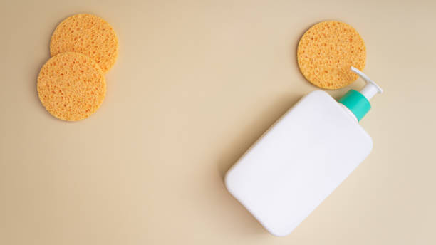 istock Reusable make-up remover pad and cleansing product in white bottle with dispenser. Reusable products for bathroom and skin care. Flat lay 1393795132