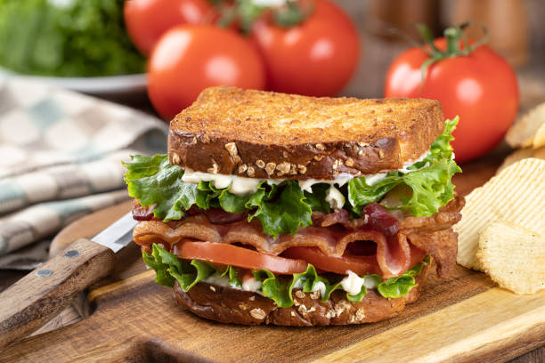 istock Bacon, lettuce and tomato sandwich on a cutting board 1393795181