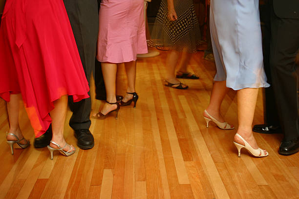 Ballroom dancing couples on hardwood floors stock photo