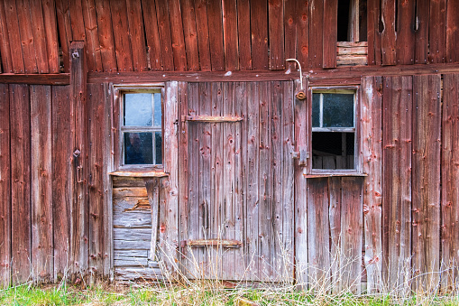 Old worn out wooden barn on ranch land in Idaho in western USA or North America.
