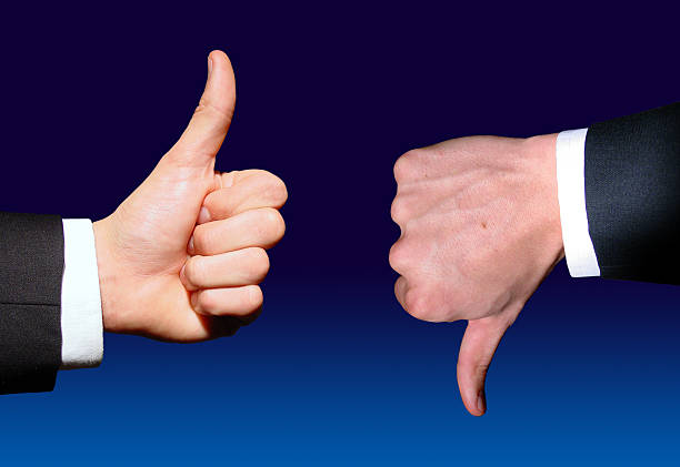 istock Businessman giving thumbs up while another gives thumbs down 139379669