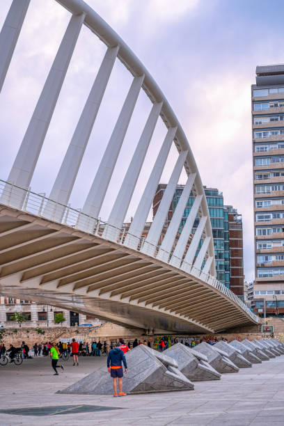 Valencia, Spain - April 30, 2022: People exercising under the Puente de la Exposicion by Santiago Calatrava. This place is a famous tourist attraction in the Spanish city.