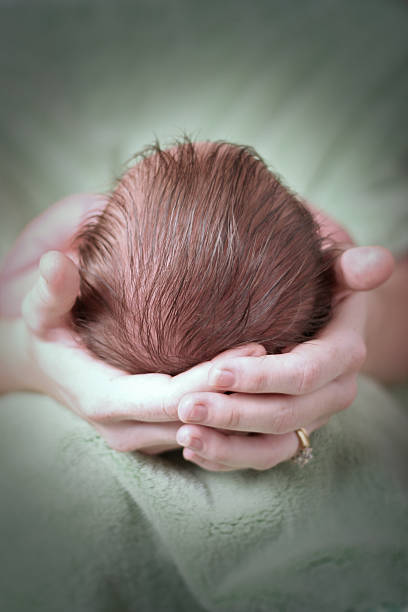 istock newborn baby held by mother 139380148