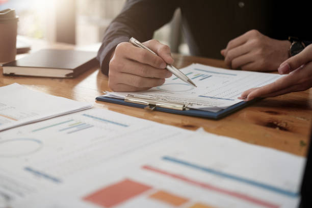 istock Close up  of businessman discussing analysis charts or graphs on desk table and using laptop computer. Close up male analysis and strategy concept. 1393803615
