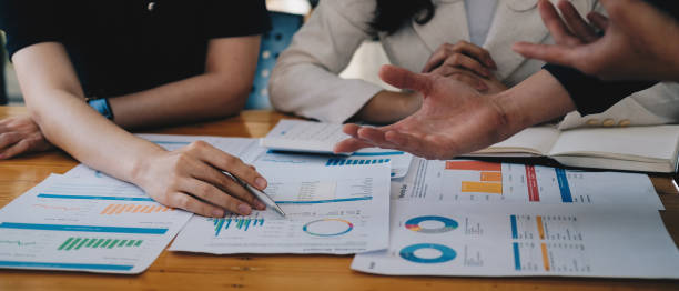 istock Business People Talking Discussing with coworker planning analyzing financial document data charts and graphs in Meeting and successful teamwork Concept. 1393803732