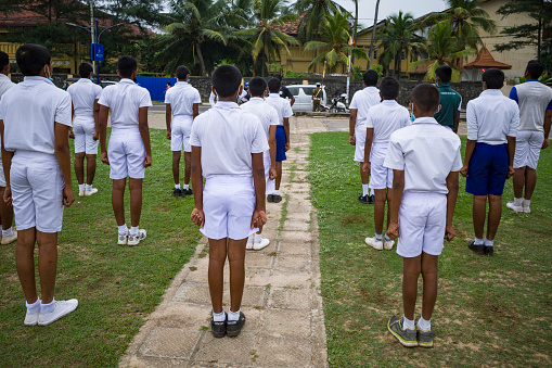 Matara, Sri Lanka March 15, 2022 A school class does morning exercise on the beach.
