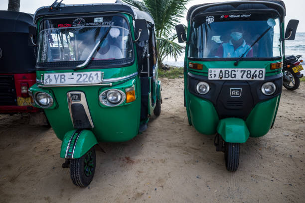 Hikkaduwa, Sri Lanka Hikkaduwa, Sri Lanka March 17 2022 Two tuktuk taxis waiting at the beach for customers. taxi sri lanka stock pictures, royalty-free photos & images