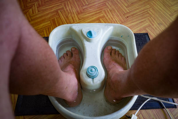 Unawatuna, Sri Lanka  A man's feet are in a footbath as part of a pedicure.