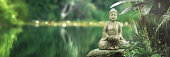istock buddha statue on a rock lakeside, natural spa background with asian spirit, tranquility in green nature, web banner concept with copy space 1393811450