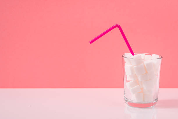 istock Glass with sugar cubes and drinking straw 1393811956