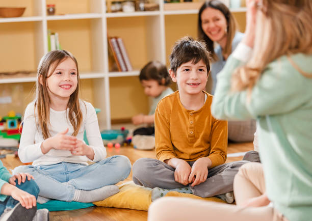 istock Preschool Children Interacting with their Teacher. Healthy learning environment. Learning through play. 1393812238