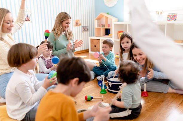istock Preschool Children Interacting with their Teacher. Healthy learning environment. Learning through play. 1393815524