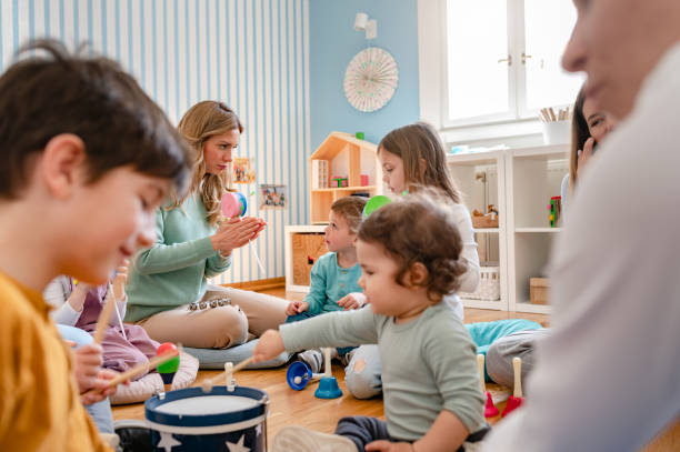 istock Preschool Children Interacting with their Teacher. Healthy learning environment. Learning through play. 1393815640