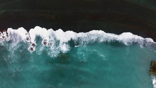 top view of azure ocean water and black volcanic sand, canary, spain. - lanzarote bay canary islands beach imagens e fotografias de stock