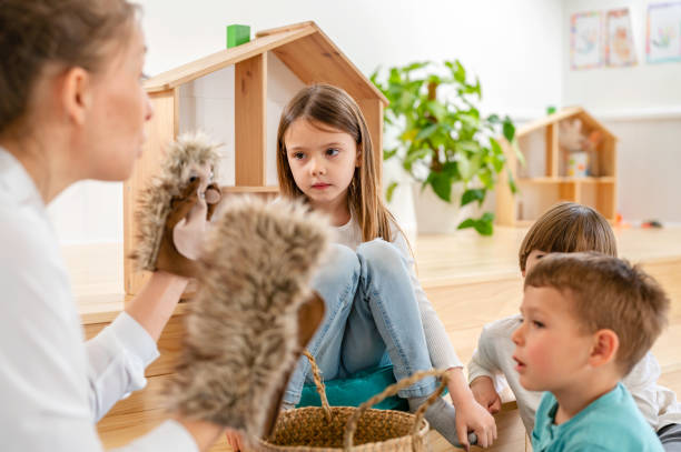 istock Preschool Children Interacting with their Teacher. Healthy learning environment. Learning through play. 1393816913