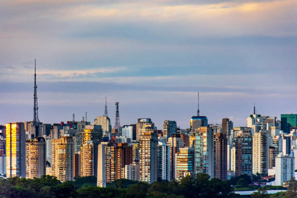 Wall of buildings, towers and communication antennas at dusk in the city of Sao Paulo, Brazil