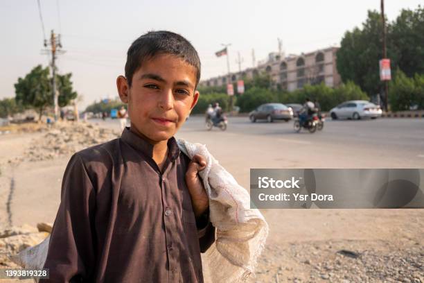 A Young Afghan Boy From Afghanistan Works As A Garbage Collector In The Street Of Karachi Pakistan Stock Photo - Download Image Now
