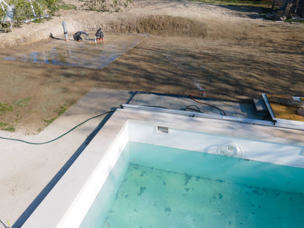 istock Drone flight over fresh earth area with grass grown next to pool 1393820026