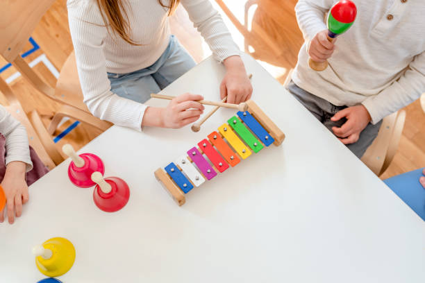 istock Preschool Children Playing Music Using Various Colorful  Instruments 1393820735