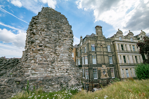Old Ruin at Rochester in Kent, England, built in the Norman style nearly 1,000 years ago. In the background are residential structures.