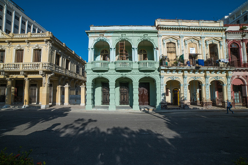 Structures situated in Paseo de Martí in various stages of full to partial restoration painted brightly.