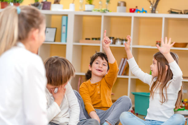 istock Preschool Children Interacting with their Teacher. Healthy learning environment. Learning through play. 1393822628