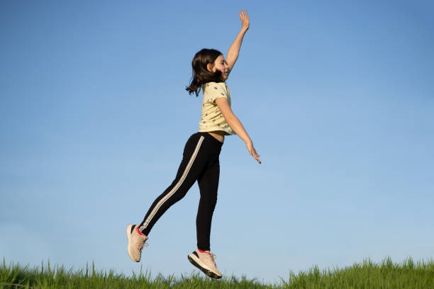 istock A small girl is jumping high 1393823731