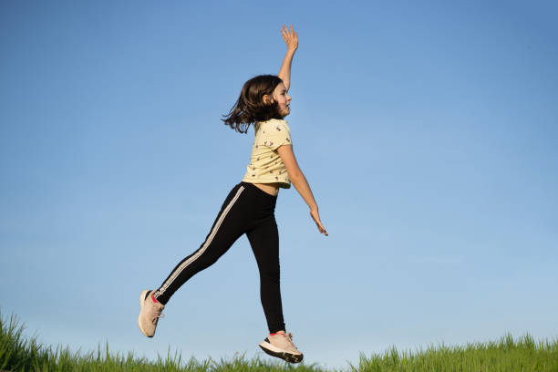 istock A small girl is jumping high 1393823734