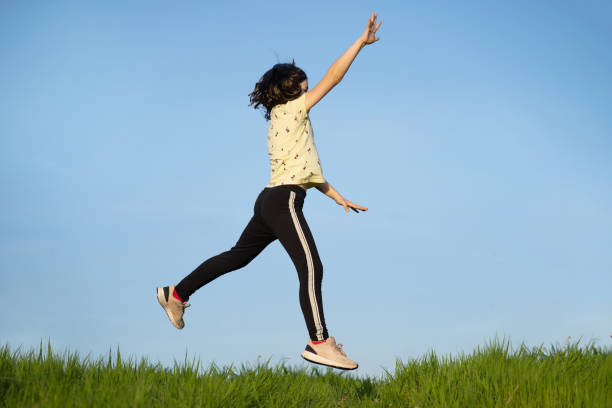 istock A small girl is jumping high 1393824244