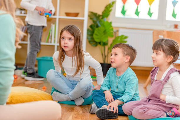 istock Preschool Children Interacting with their Teacher. Healthy learning environment. Learning through play. 1393824449