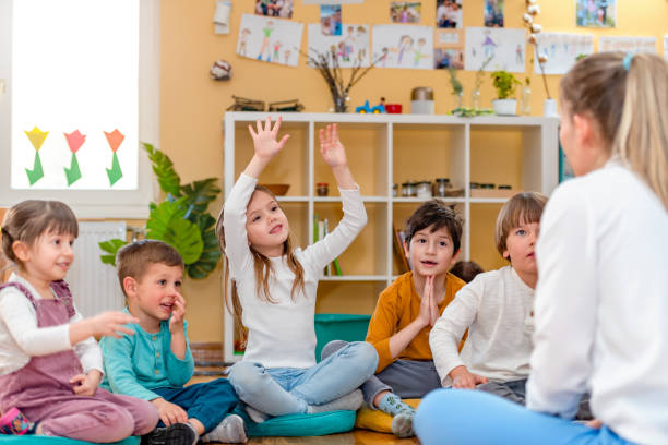 istock Preschool Children Interacting with their Teacher. Healthy learning environment. Learning through play. 1393824494