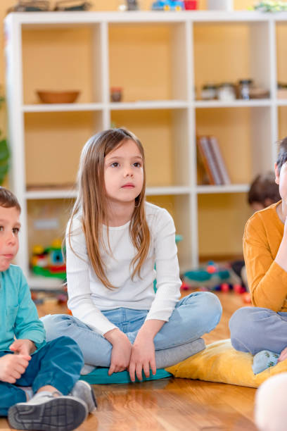 istock Preschool Children Interacting with their Teacher. Healthy learning environment. Learning through play. 1393824798