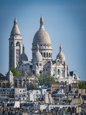 Sacre-Coeur de Montmartre in early morning light. Soft color effects with added grain.