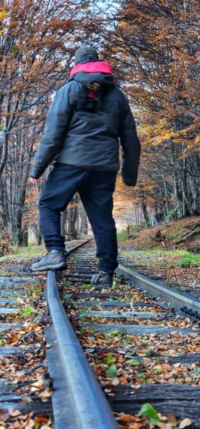 man  standing  on  the  tracks  of  an  abandoned  train
