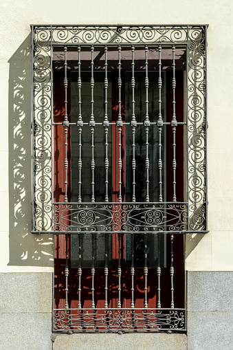 Wrought iron grille on a window in Madrid, Spain