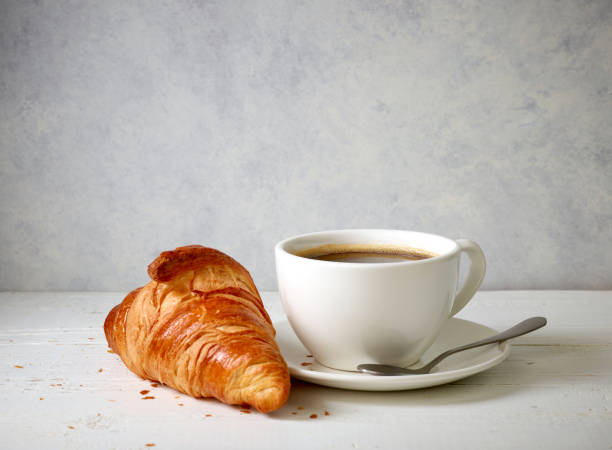istock freshly baked croissant and cup of coffee 1393826585